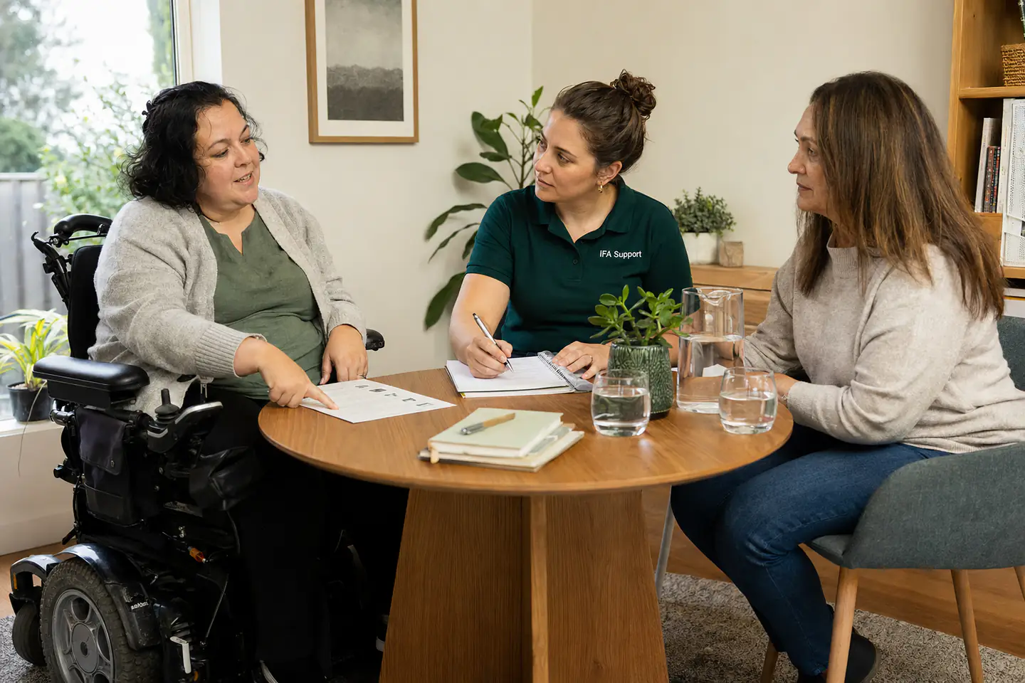 Participant meeting with an IFA support coordinator and a family member.
